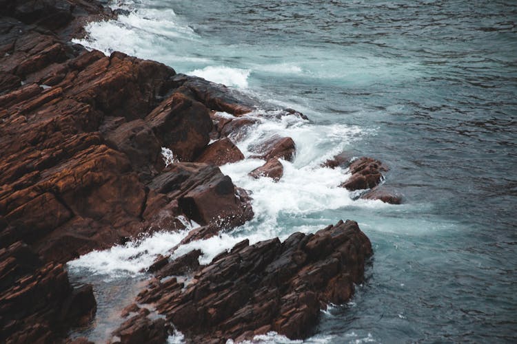 Rugged Mountain And Foamy Sea In Stormy Weather