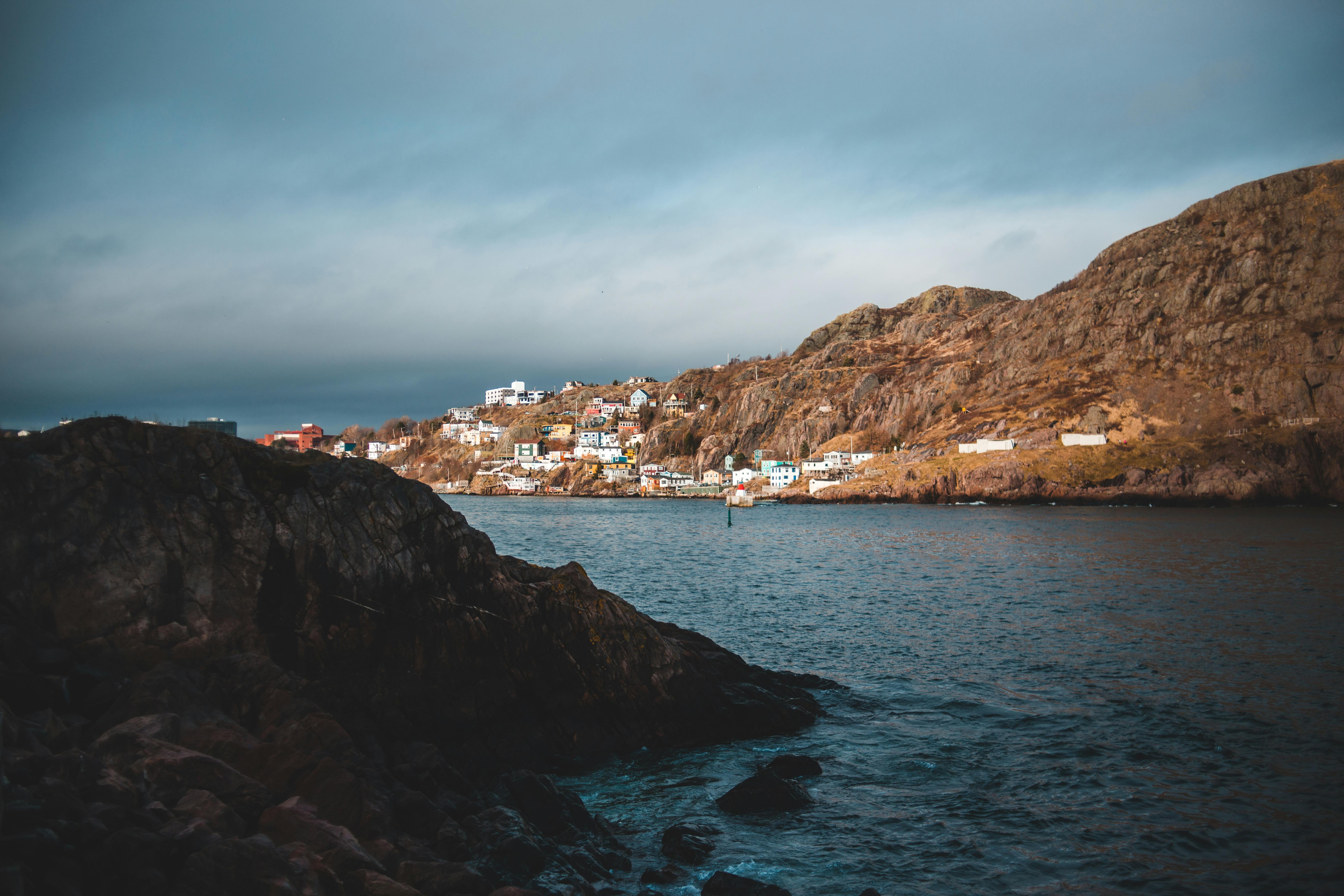 sea between majestic mountains with houses in town