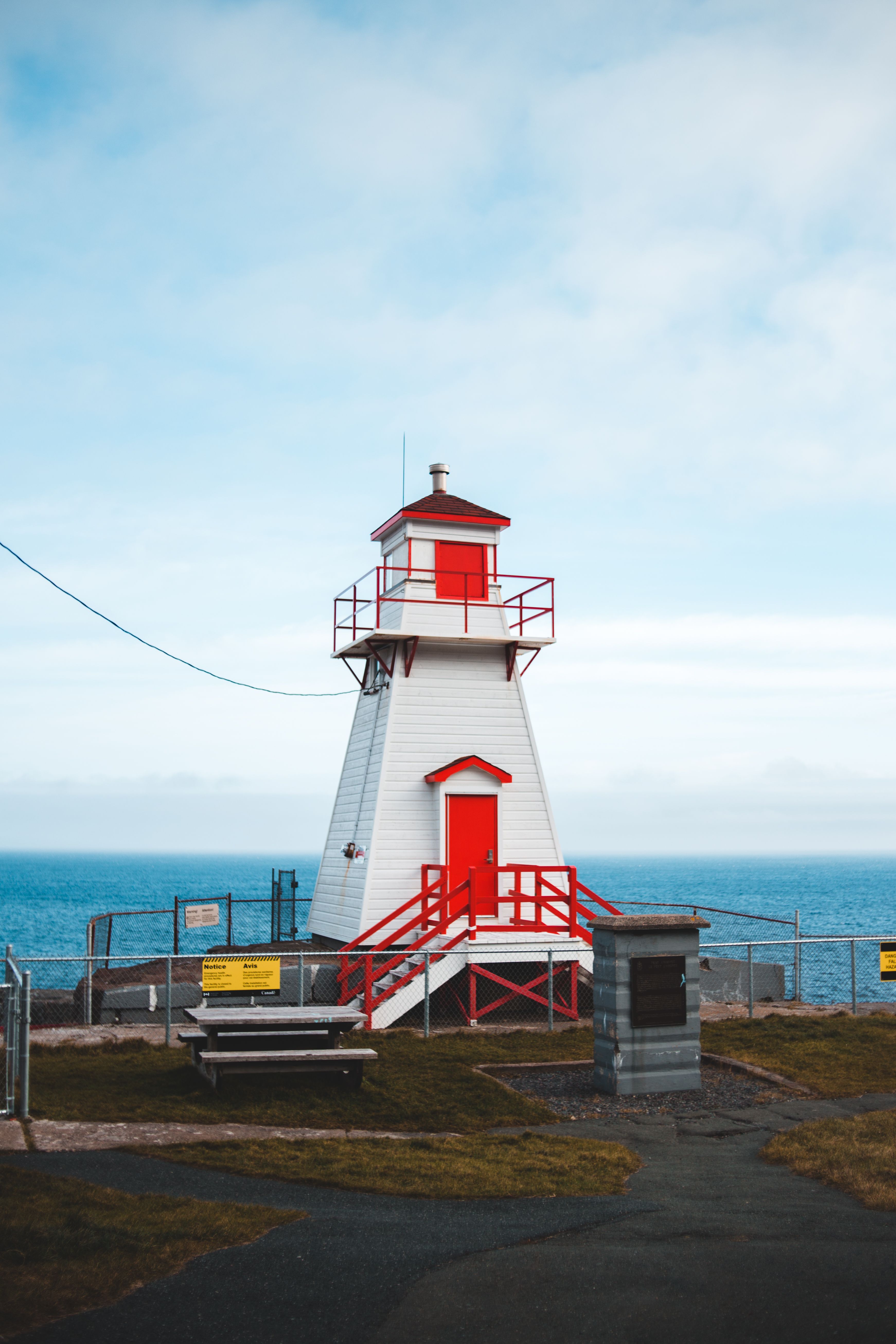 White and Red Lighthouse Near Body of Water · Free Stock Photo