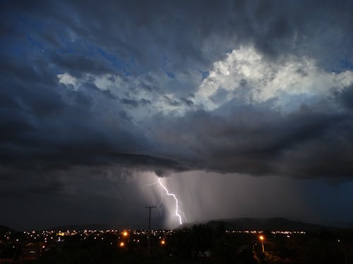 Lightning over dark city at night time