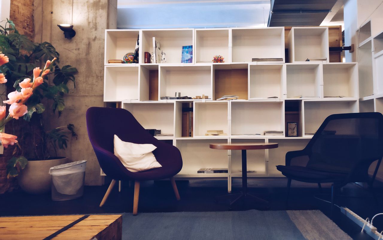Stylish living room with modern furniture and bookshelves