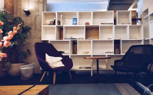 Free A stylish living room featuring modern furniture, bookshelves, and decorative plants. Stock Photo
