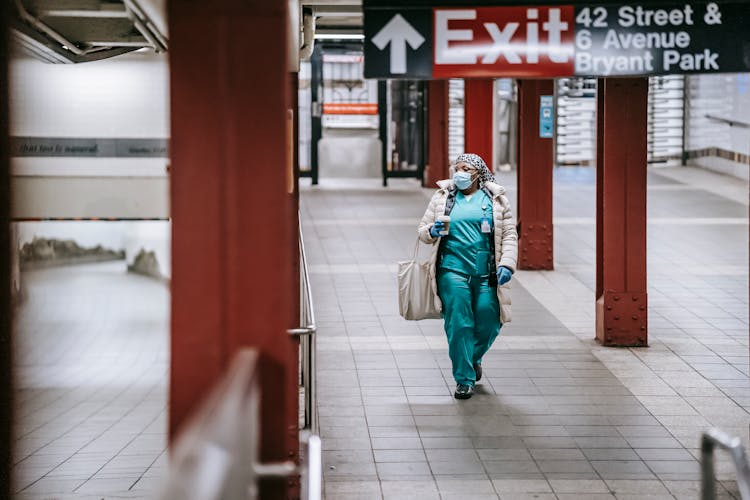 Medical Specialist In Uniform And Protective Mask On Subway Station