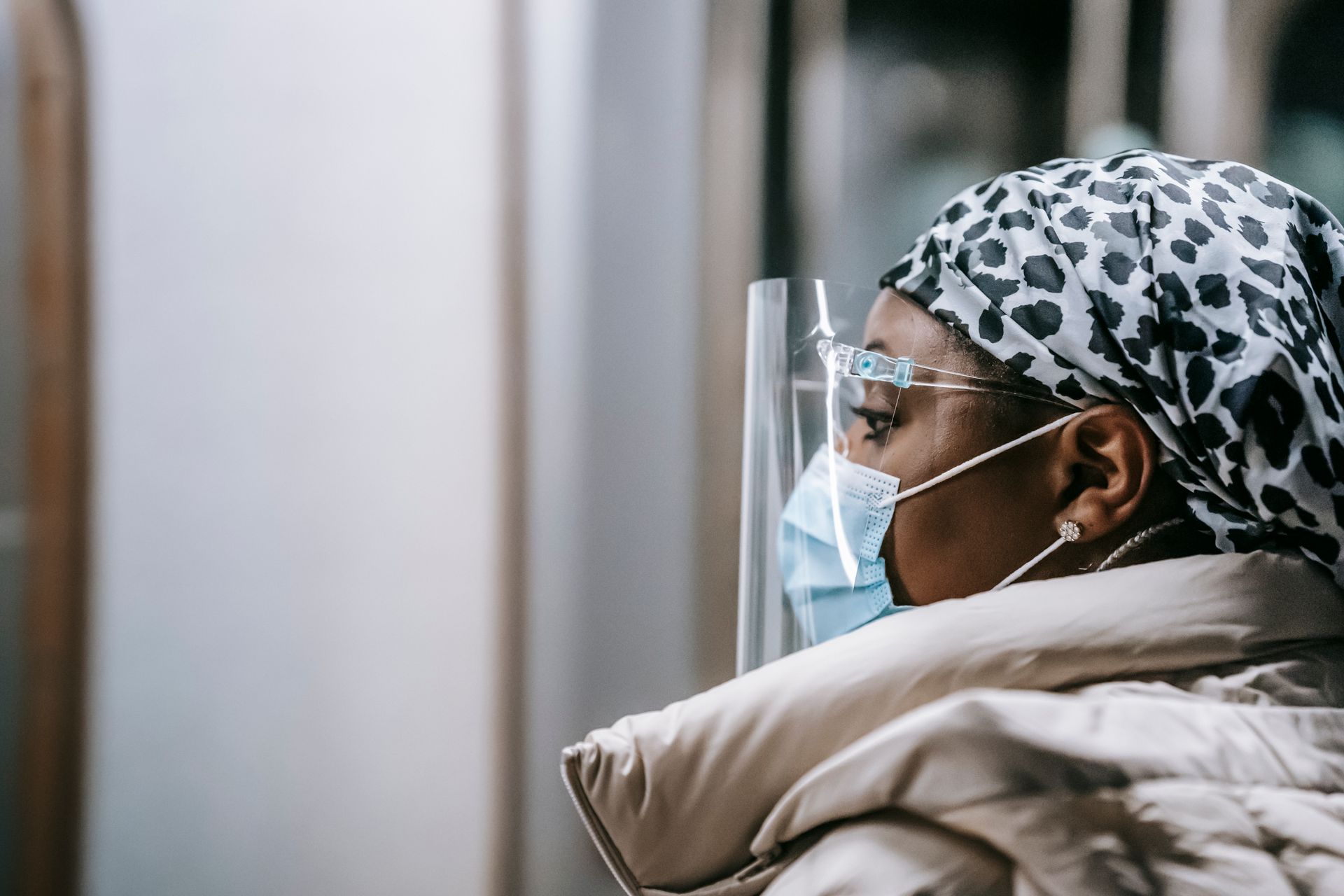 Emotionless black woman in protective mask and face shield