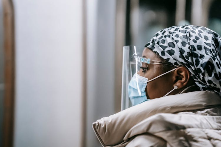 Emotionless Black Woman In Protective Mask And Face Shield