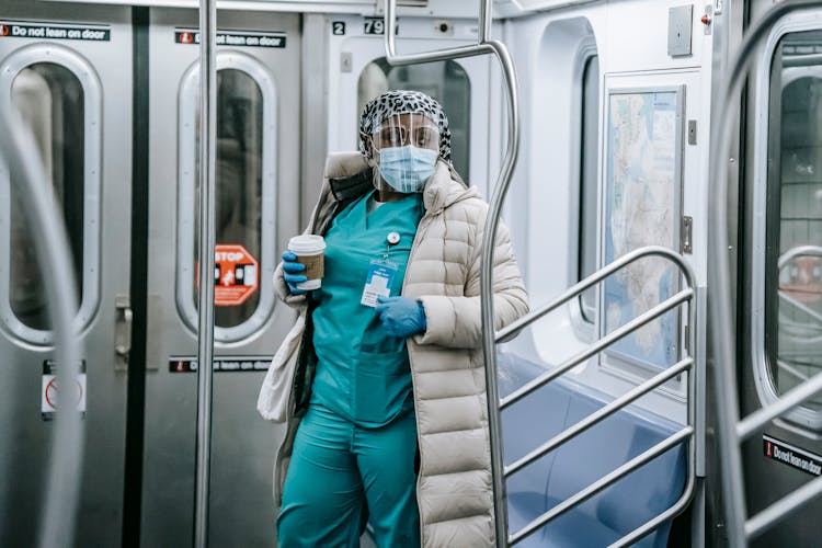 Black Nurse In Face Mask Riding Metro Train