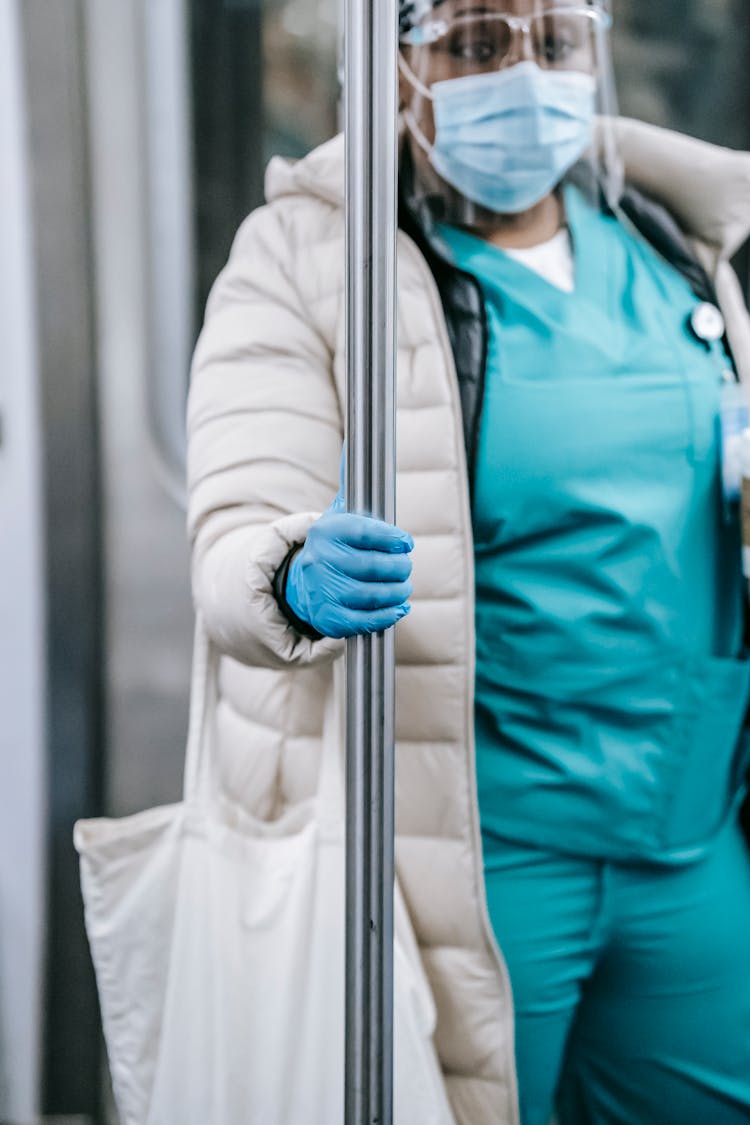 Crop Black Nurse In Mask Riding Metro Train