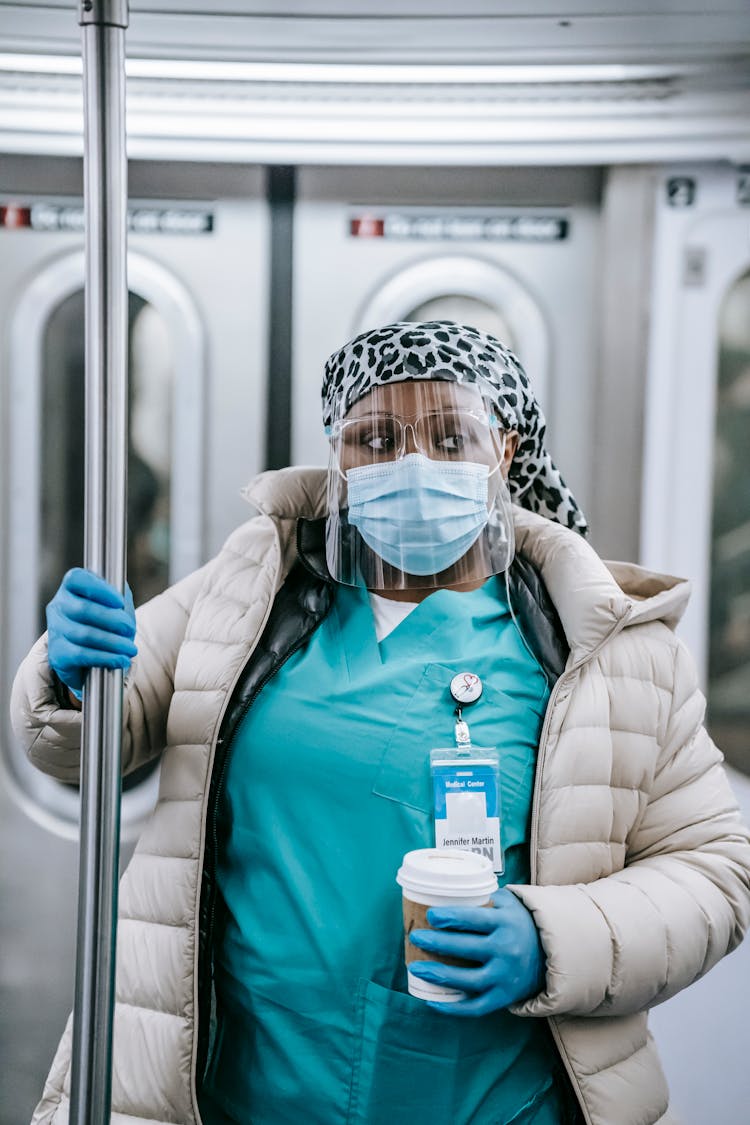 Thoughtful Black Nurse In Mask And Gloves Riding Metro Train