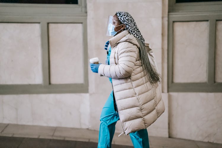 Black Nurse In Protective Mask Walking On Street