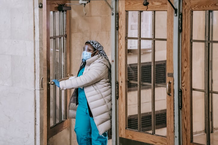 Black medic opening building door in city