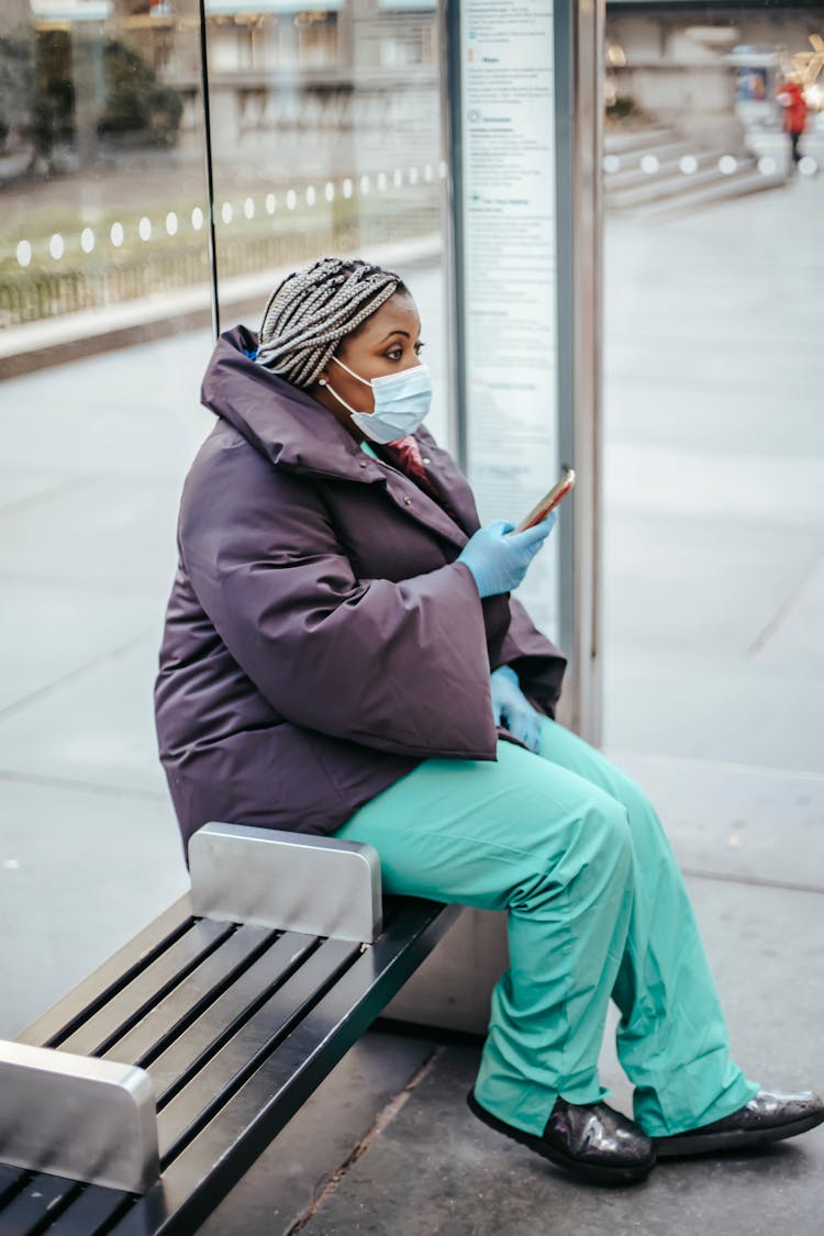 Black Doctor With Smartphone On Street Bench