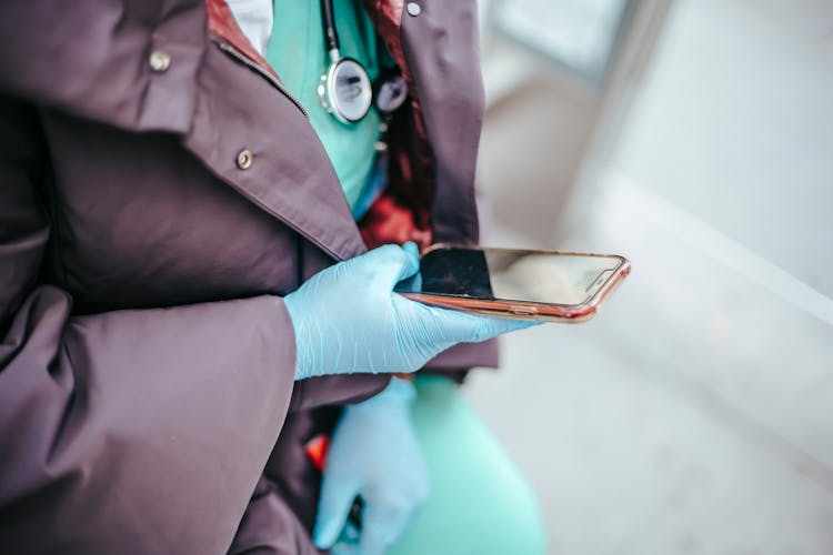 Crop Doctor In Uniform Surfing Internet On Smartphone