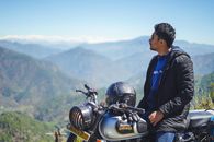 Man in Blue Jacket and Black Pants Sitting on Black Motorcycle