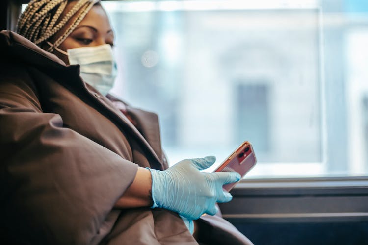 Crop Black Doctor Chatting On Smartphone In Public Transport