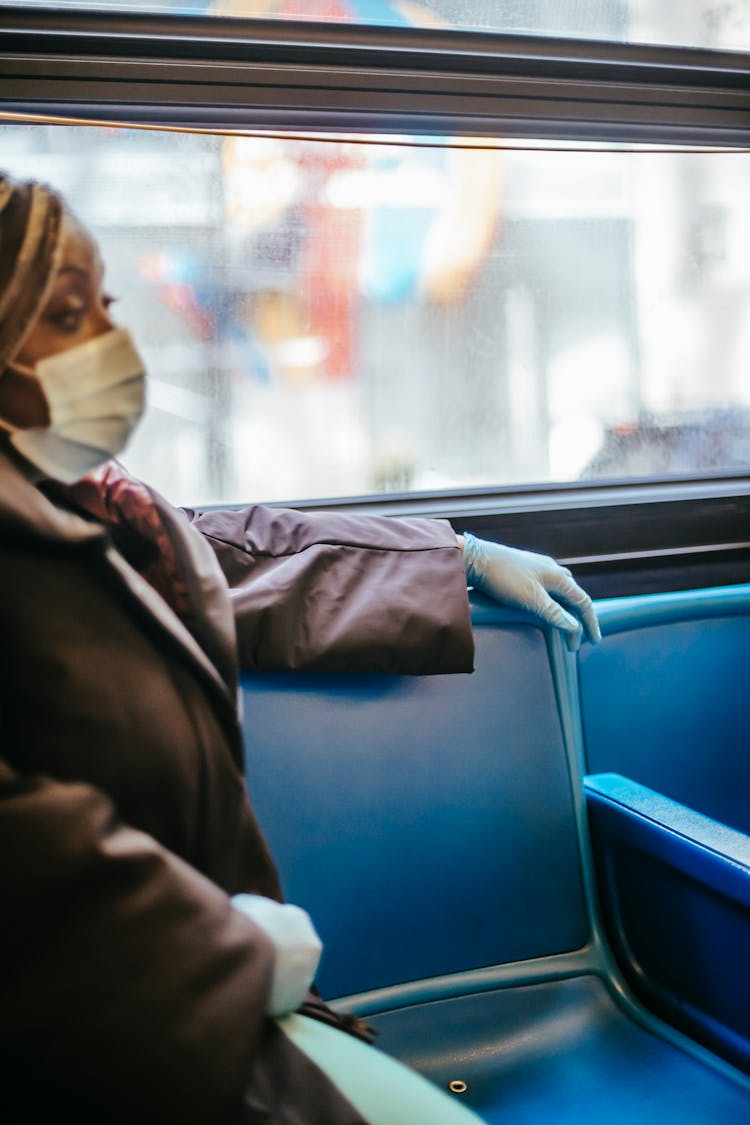 Black Woman Riding Bus In Pandemic