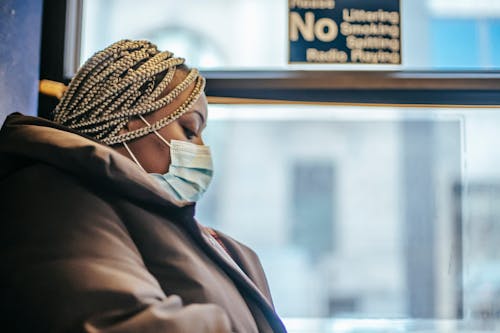 Free Black woman in epidemic riding in bus Stock Photo