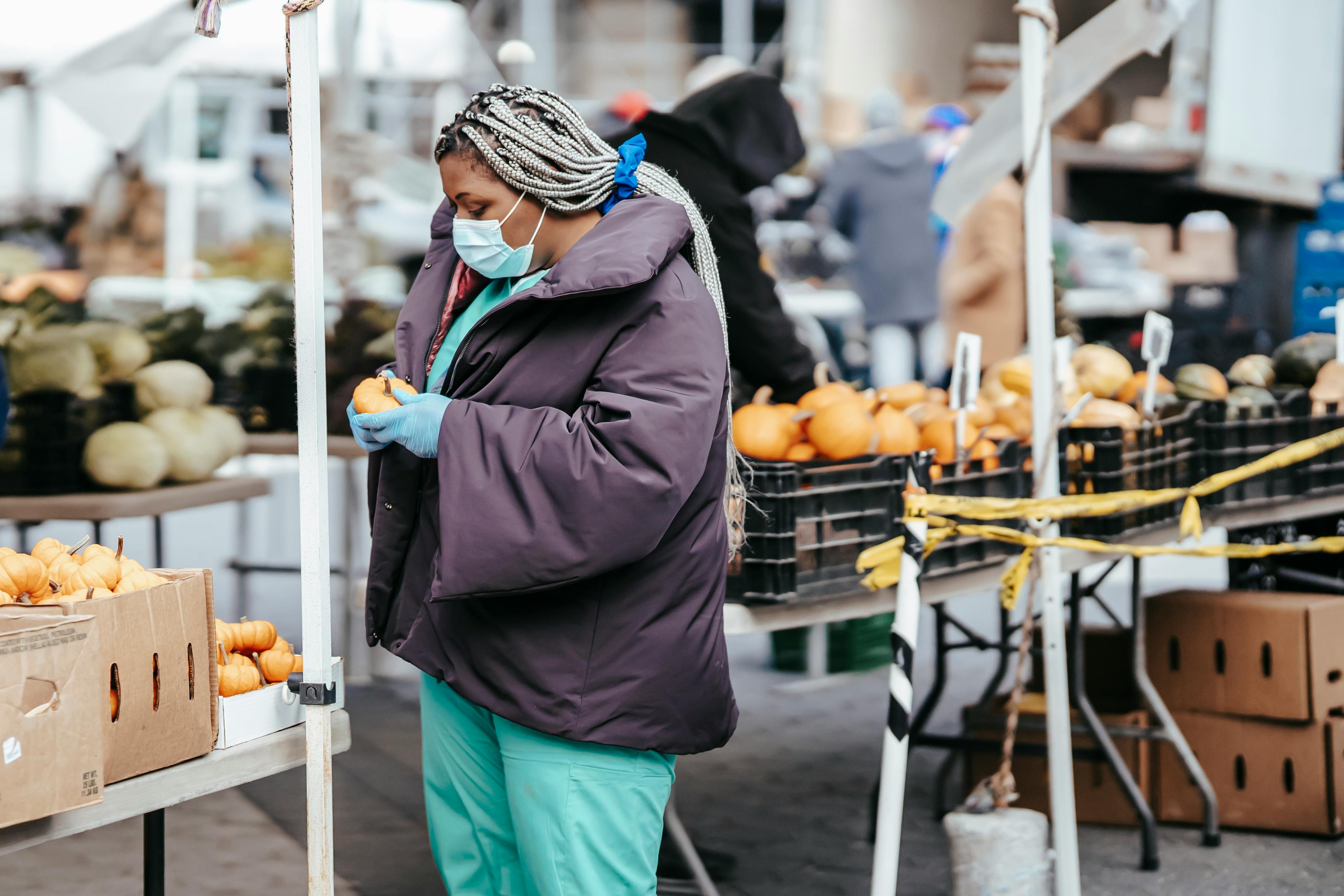 black lady nurse choosing food in market