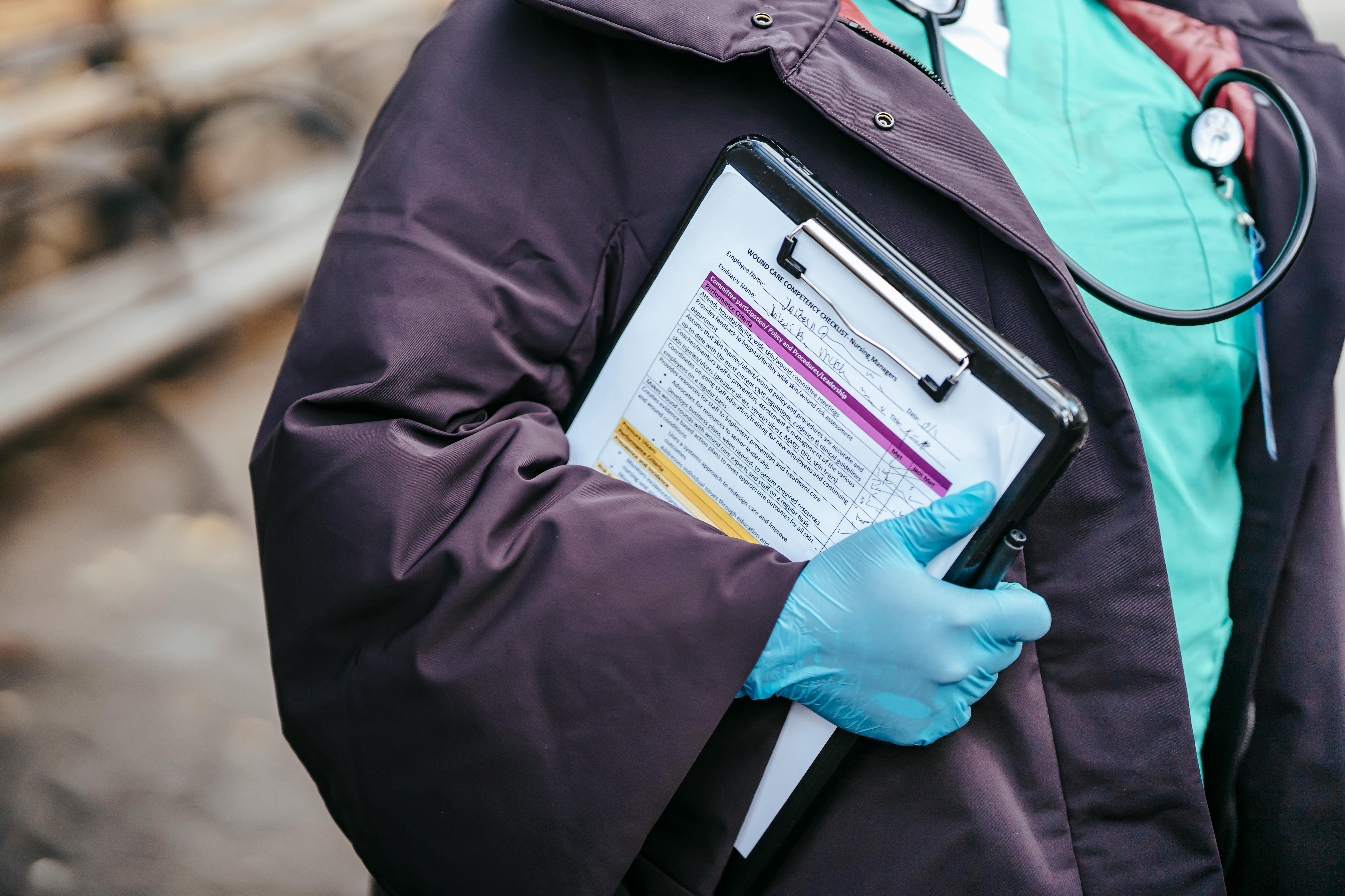 faceless lady nurse with papers in street in coronavirus