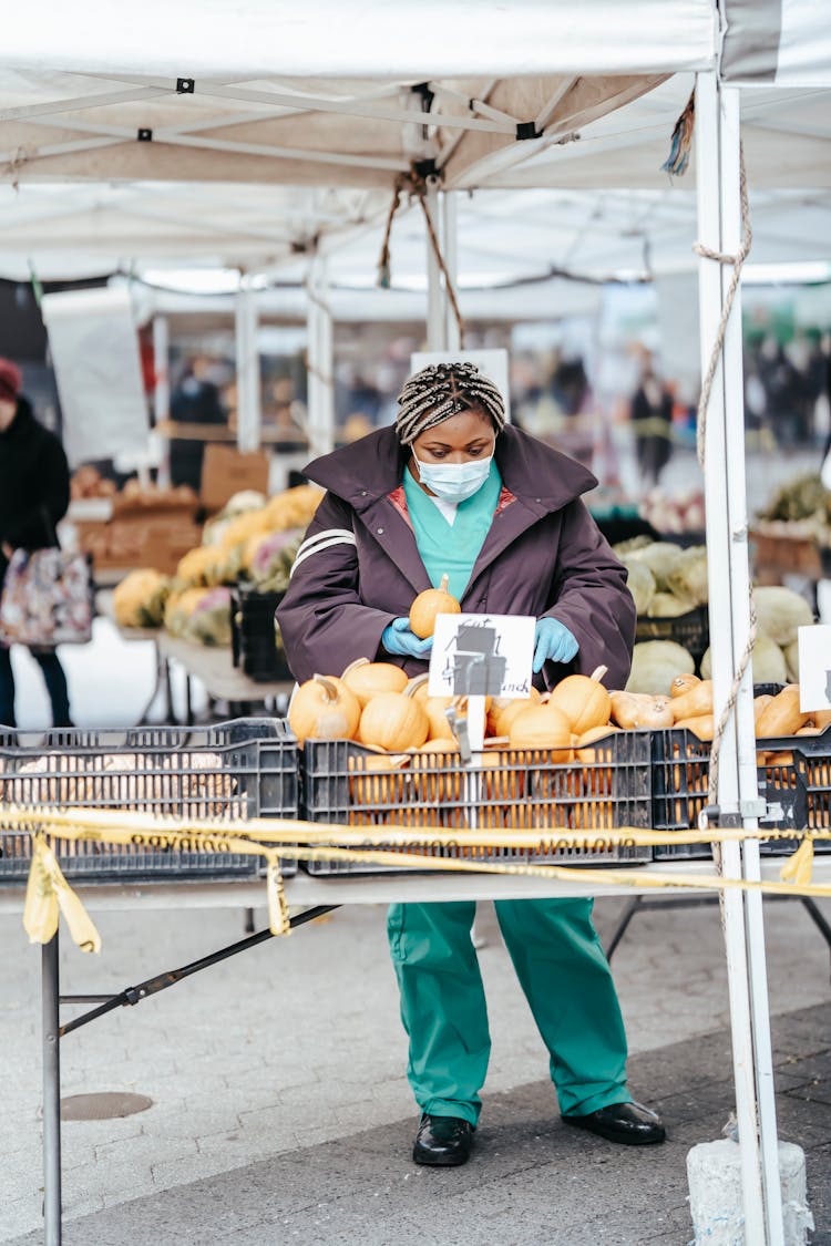 African American Female Nurse Choosing Products In Street Market