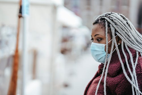 Black female in mask outdoors in epidemic