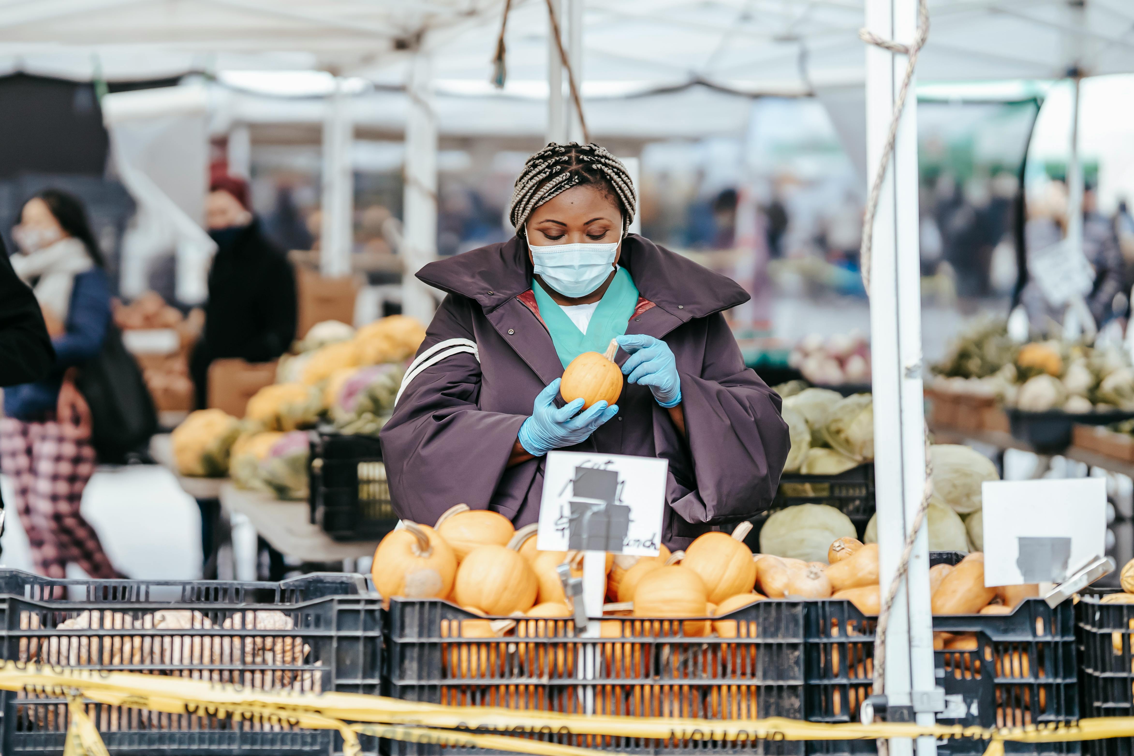 black lady doctor in market picking food