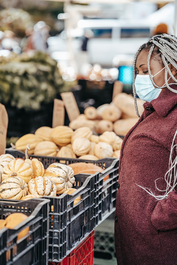 African American Female In Mask Picking Vegetables On Market