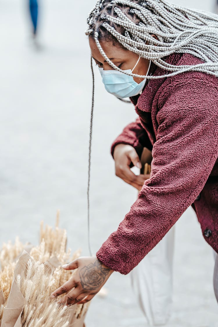 Black Lady Picking Bouquet Of Dried Wheat In Street