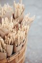 Bouquet of dried wheat sprigs in bucket on road