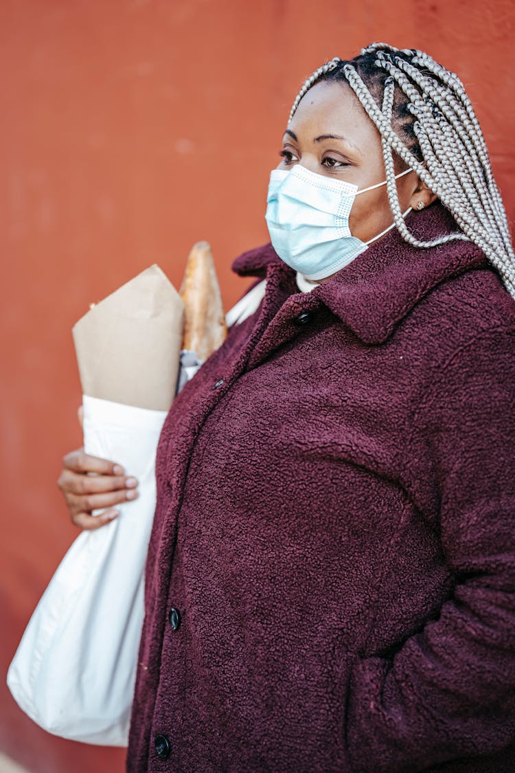 African American Woman In Mask With Shopping Bag