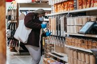 Black woman choosing grains in supermarket