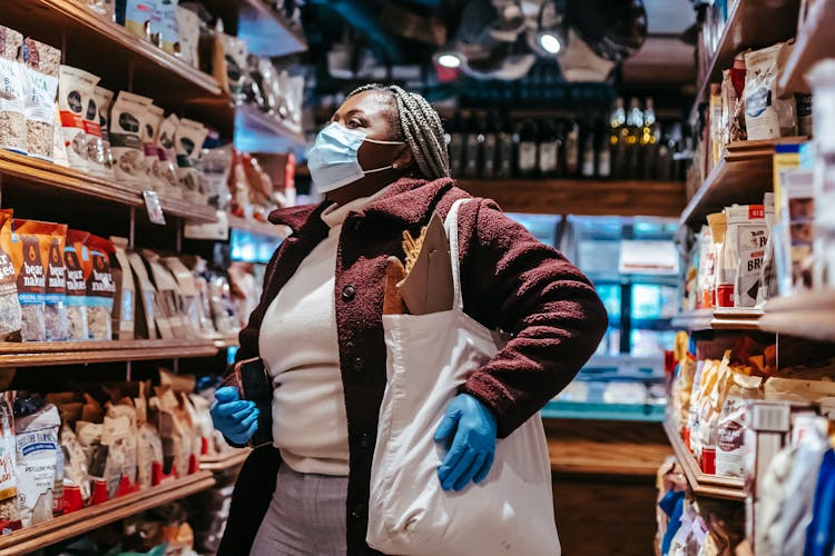 Black Woman Choosing Food In Grocery Store