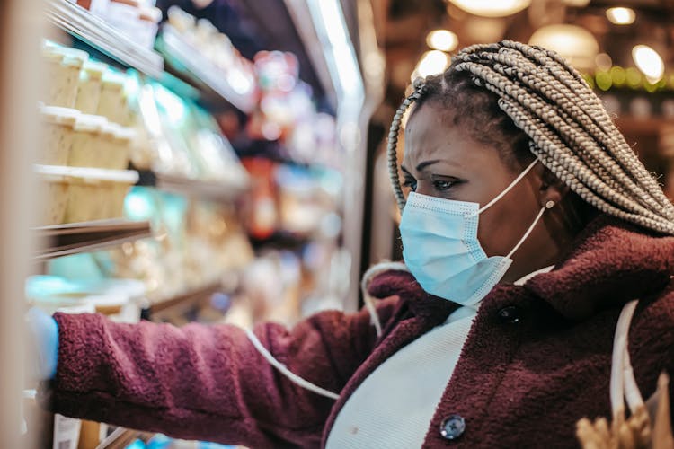 Black Frown Woman Choosing Purchases In Supermarket