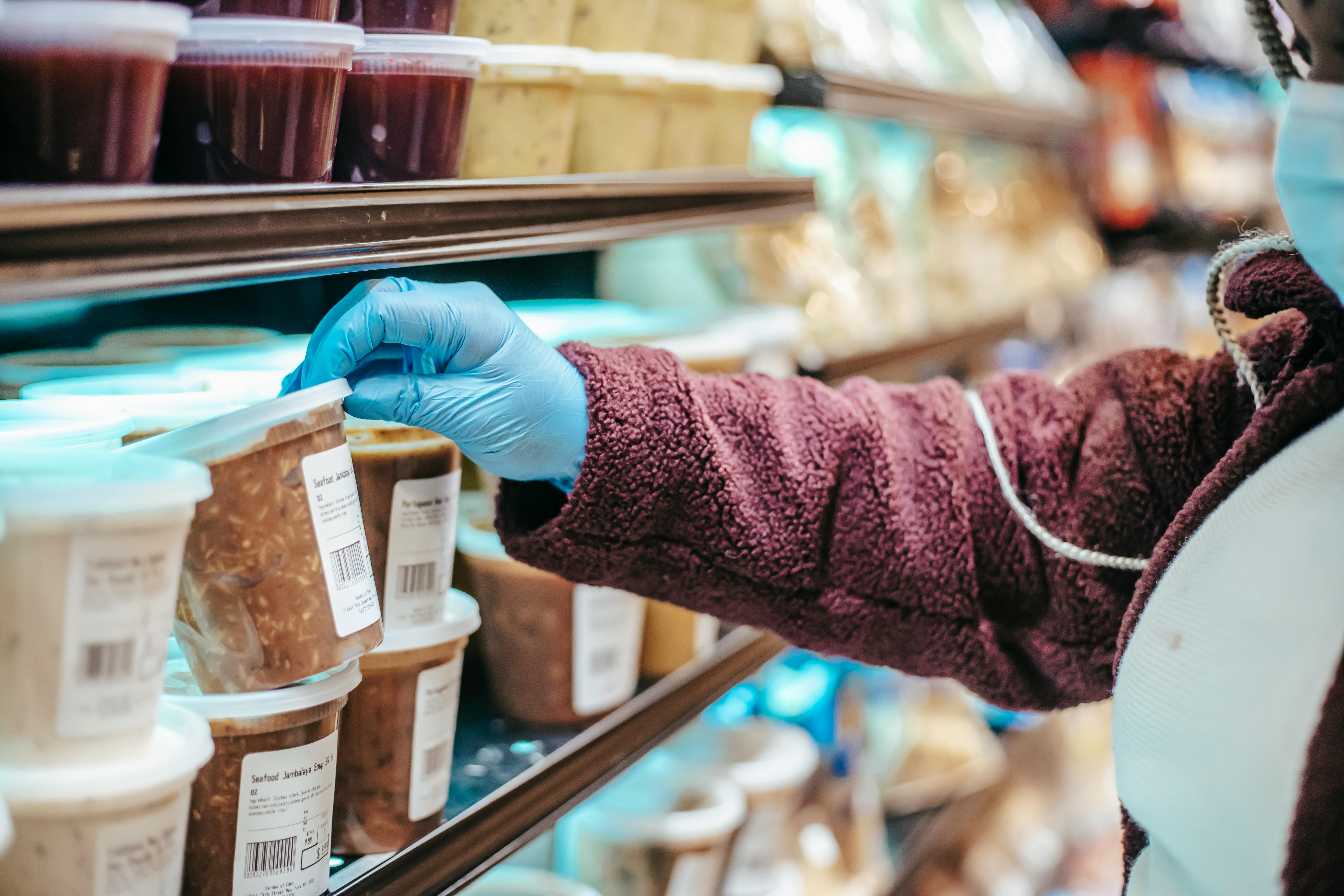 woman choosing frozen product in supermarket