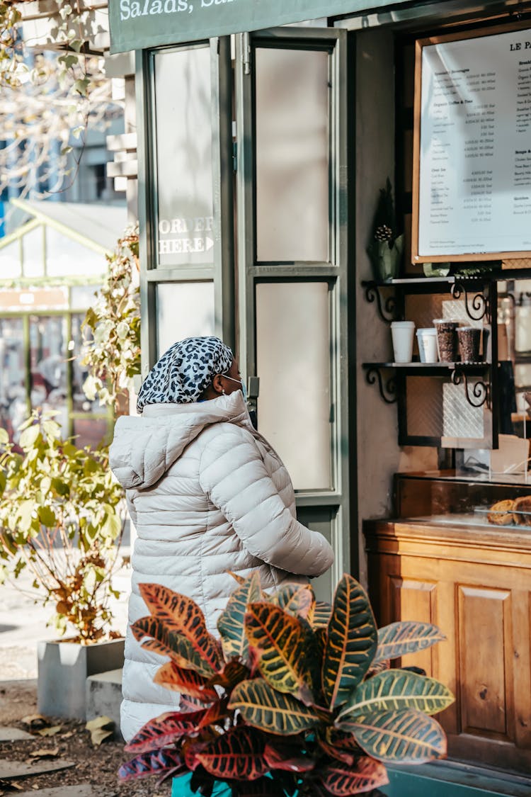 Black Woman Choosing Hot Drink In Coffee House