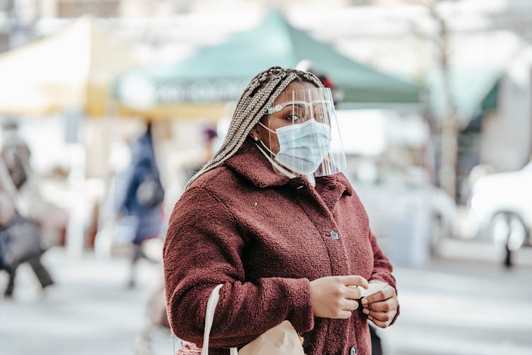 Anonymous Black Female In Mask In Street