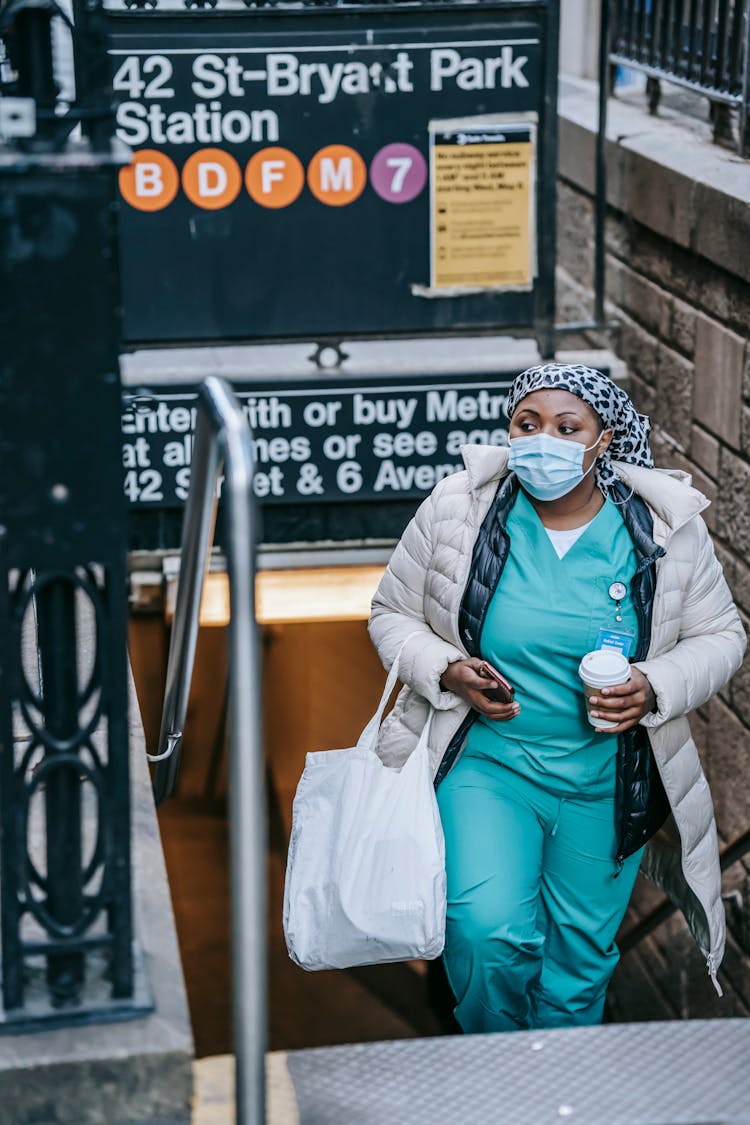 Adult Black Nurse In Mask Leaving Metro Station