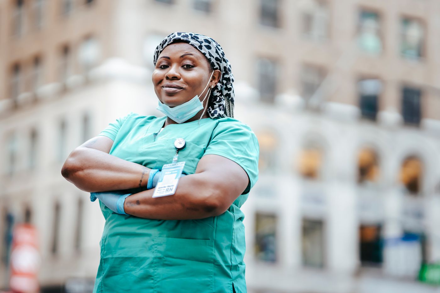 Healthcare professional in medical uniform smiling in a clinical setting