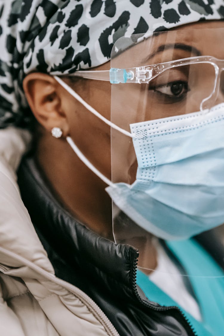 African American Woman In Face Mask During Work