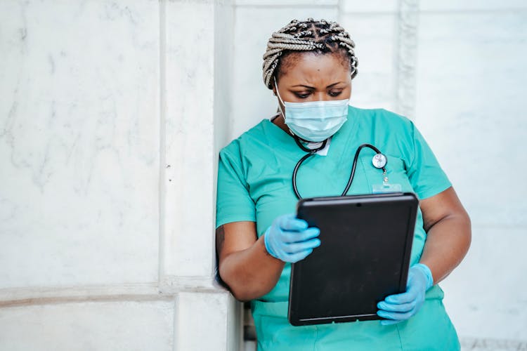 Focused Woman With Documents In Hospital