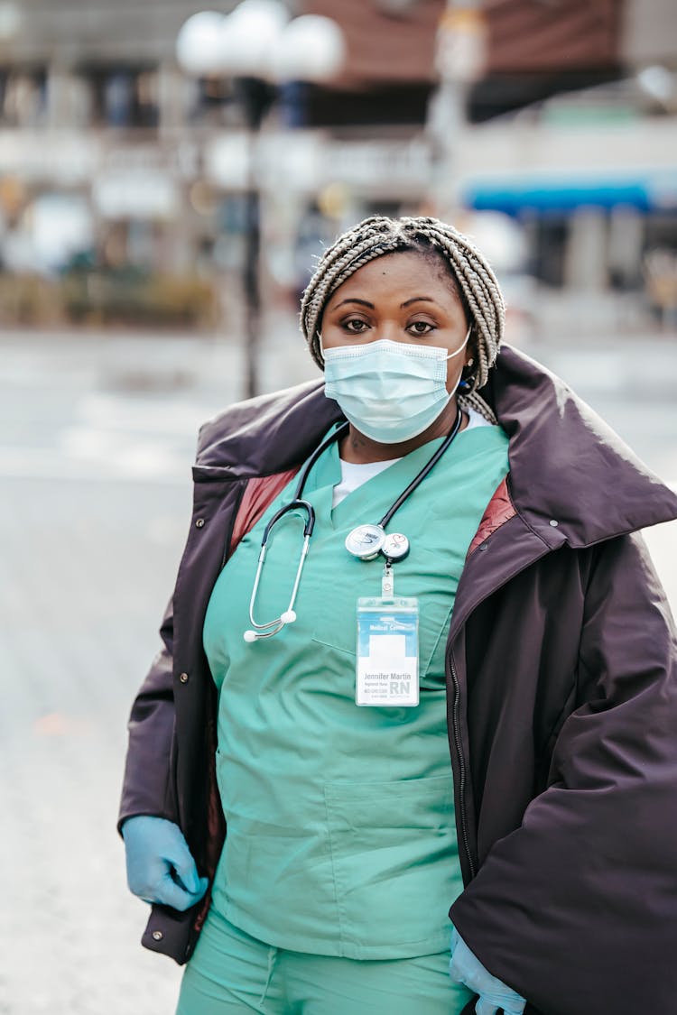 Black Doctor In Mask Standing On City Street