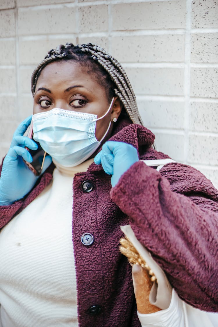 Black Female In Protective Mask Talking On Smartphone