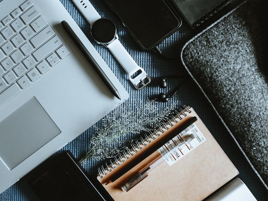 Product Photos Without Photoshop: 6 AI Tools Flatlay of a modern workspace with a laptop, smartwatch, notebook, and tech gadgets, ideal for tech-themed projects.