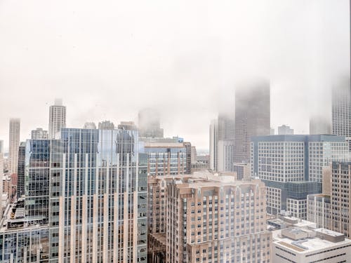 Aerial Shot of Thick Fog Covering the High Rise Buildings 