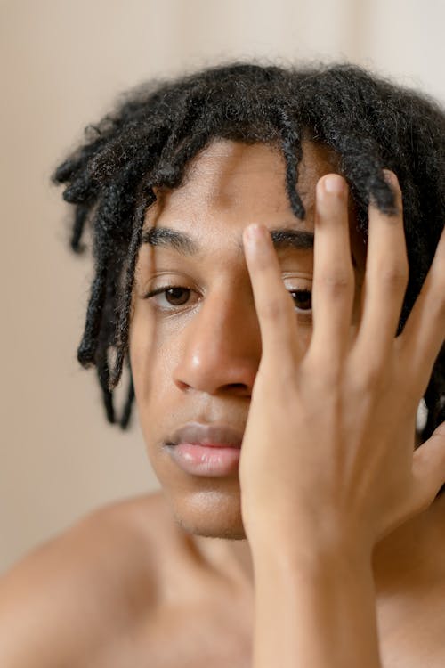 Topless Man Covering His Face With His Hand