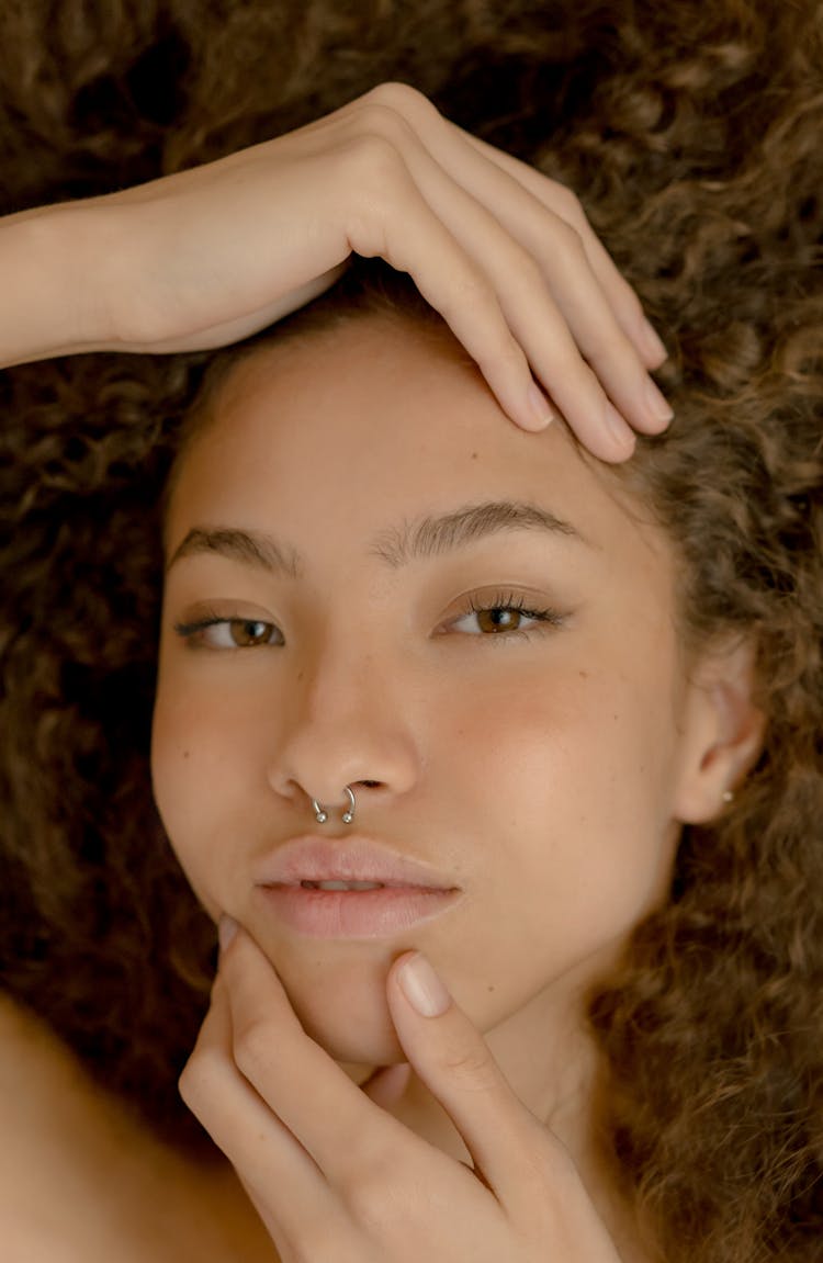 Portrait Of A Girl With A Nose Piercing Touching Her Hair