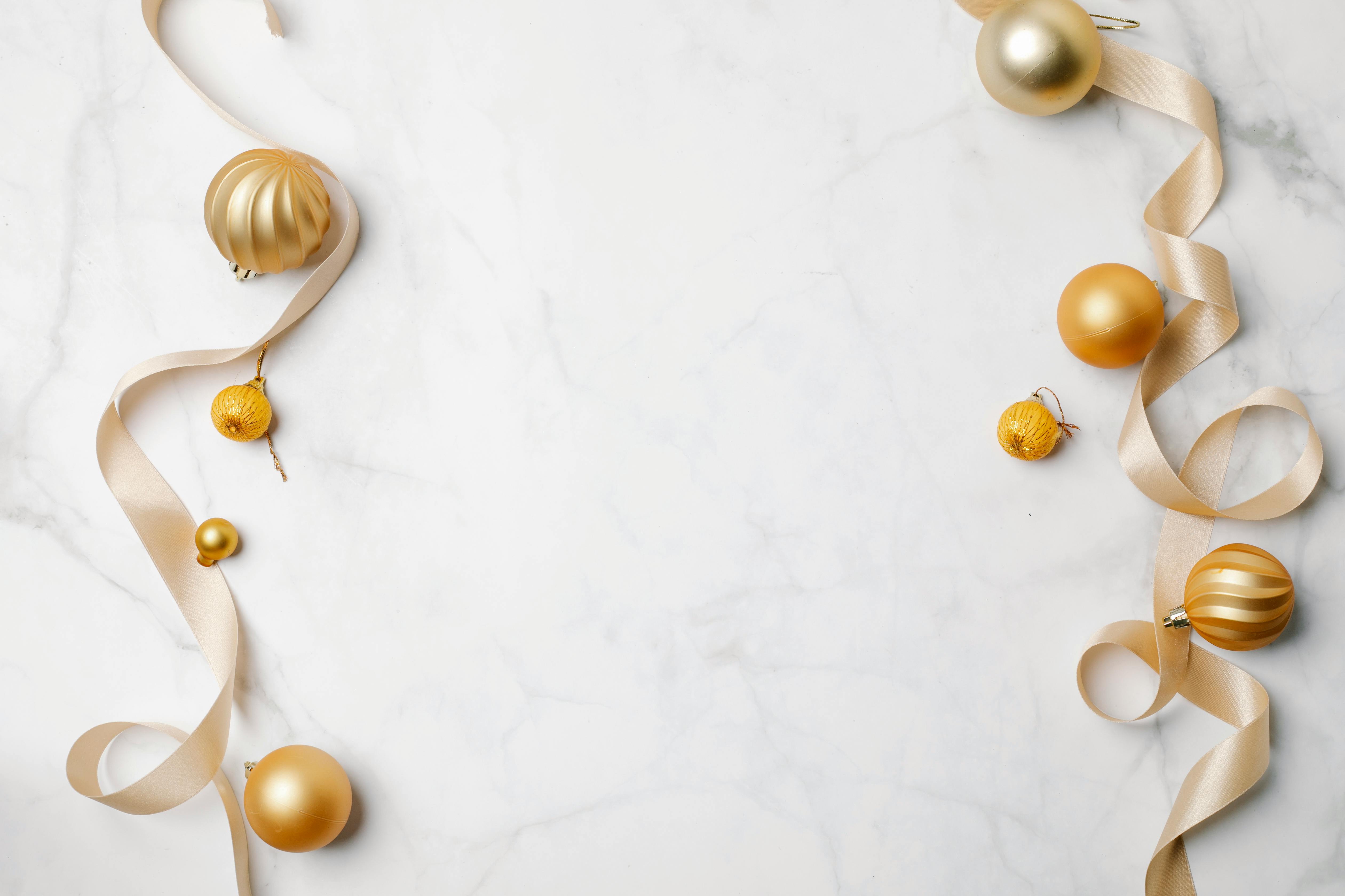 Christmas composition with shiny hanging baubles · Free Stock Photo
