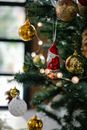Decorated Christmas tree with baubles and Santa Claus statuette
