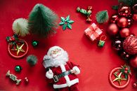 From above of assorted baubles and New Year decoration near Saint Nicholas statuette with lantern