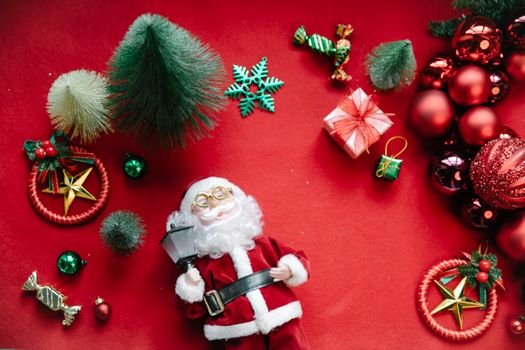From above of assorted baubles and New Year decoration near Saint Nicholas statuette with lantern