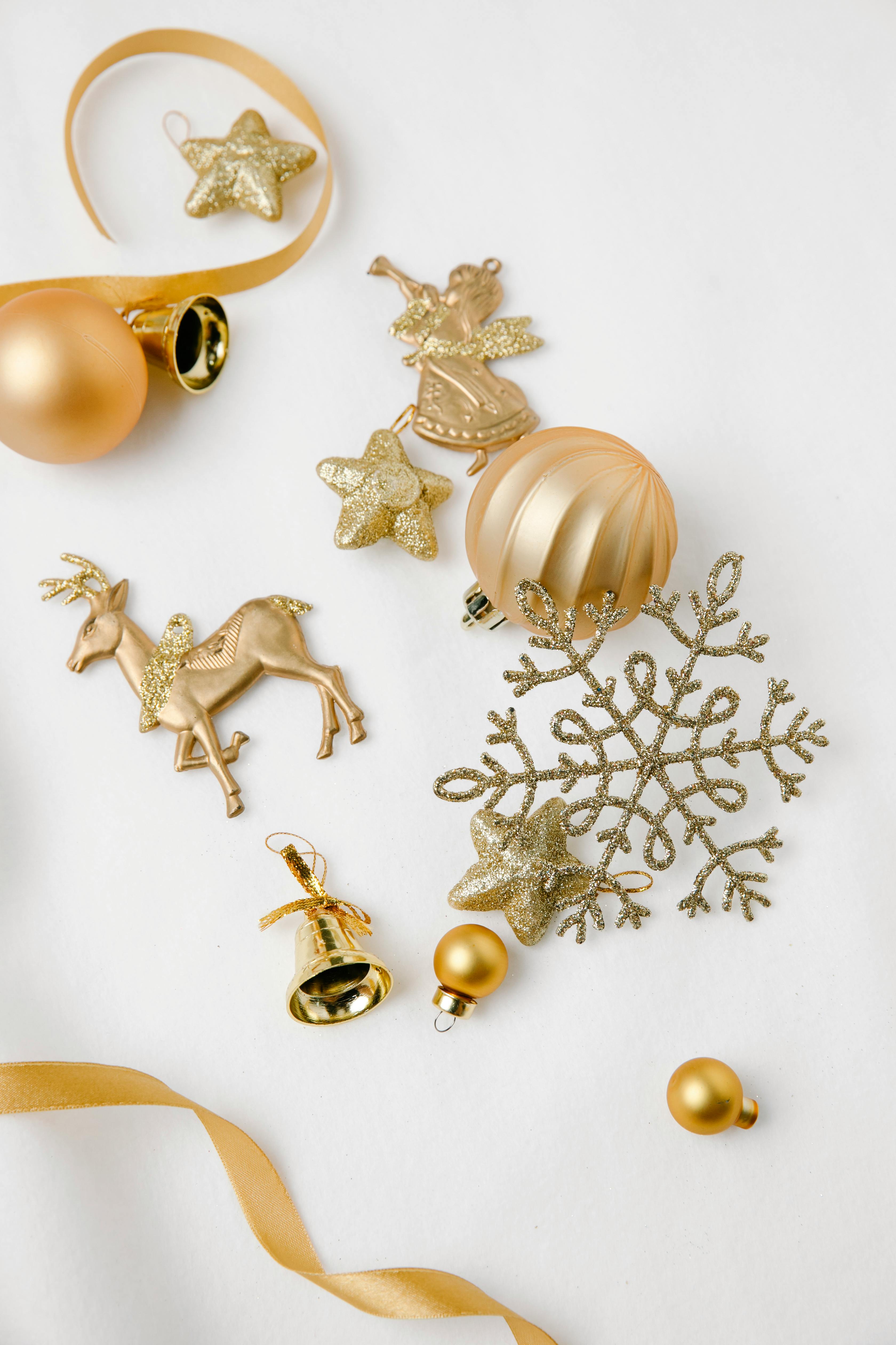 assorted golden christmas decor on white background